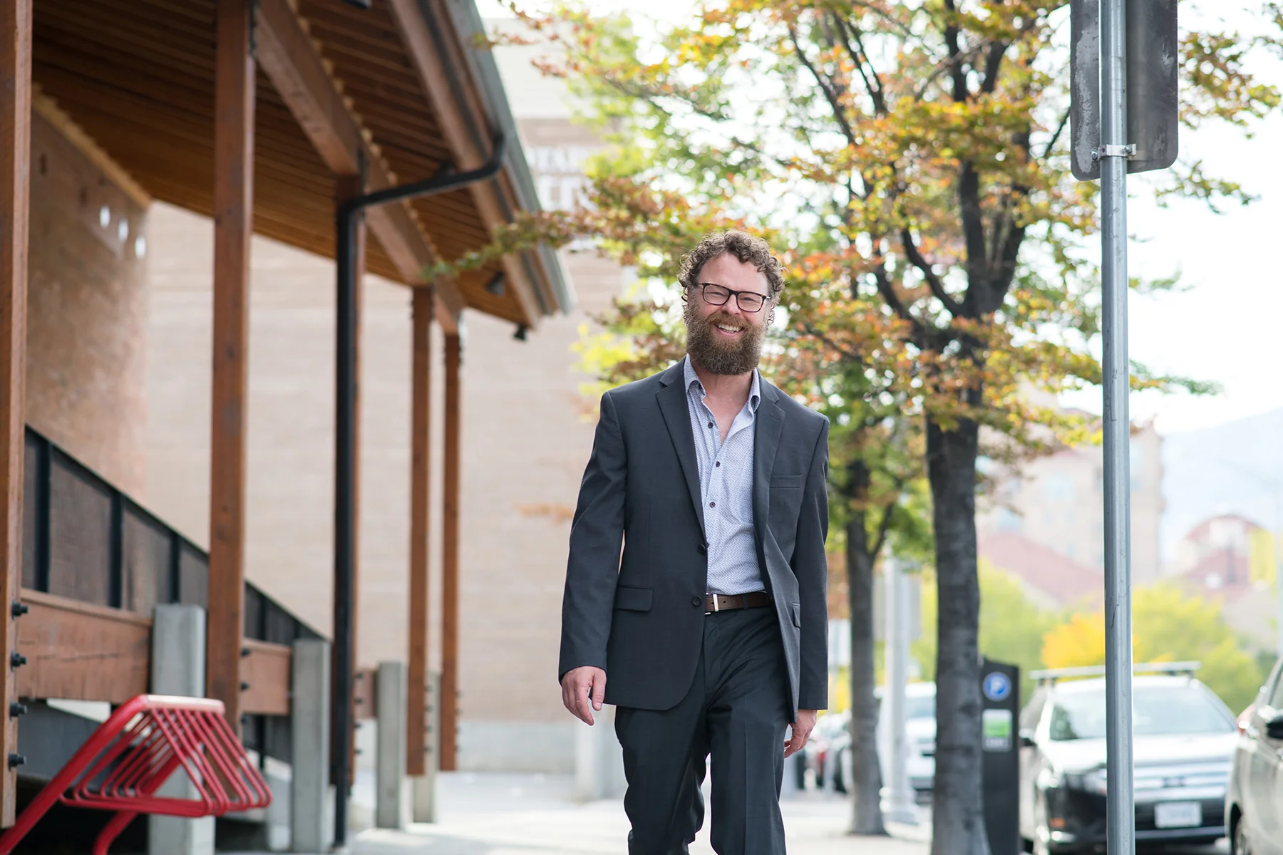 Kelowna realtor Byron Armstrong walking outdoors inviting clients to buy or sell a home in Kelowna BC.